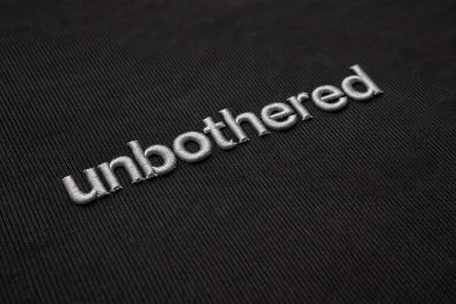 Unbothered Tee — Black / Grey Embroidery